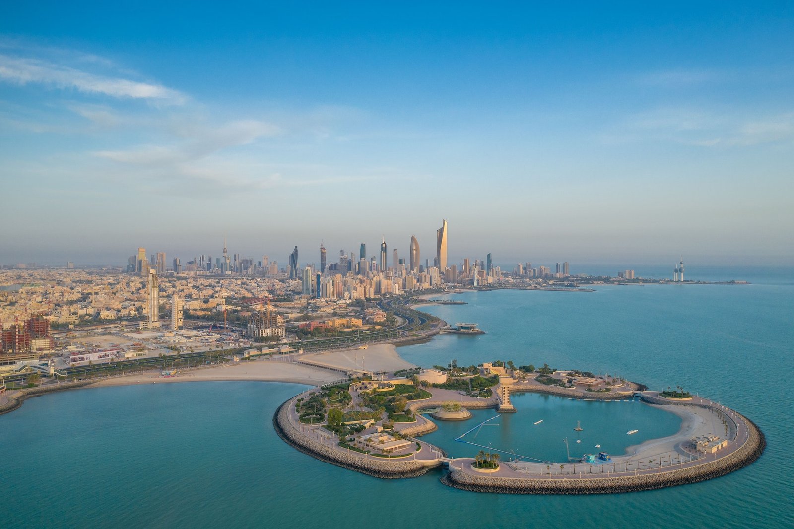 High-angle shot of The Green Island with a skyline of the city of Kuwait in the background